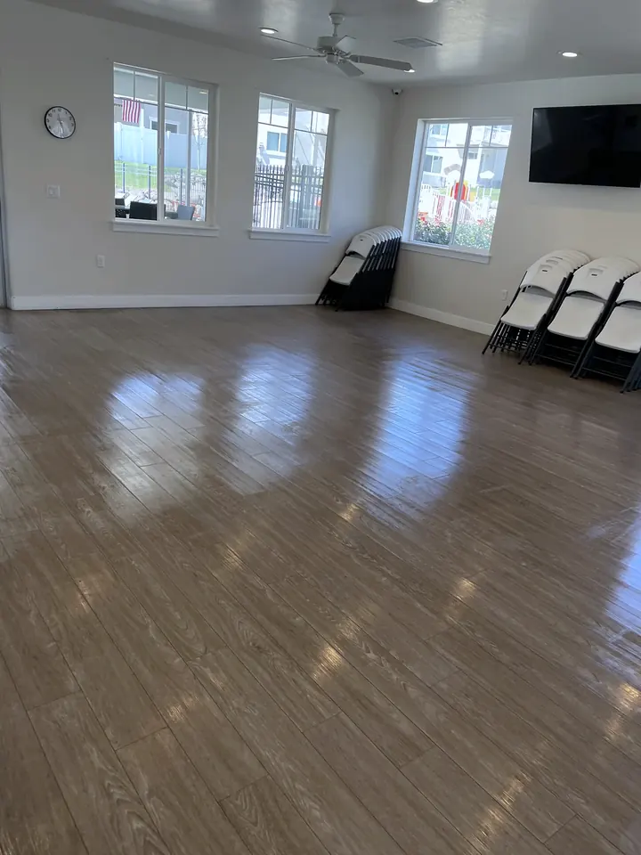 A bright clubhouse room with polished floors