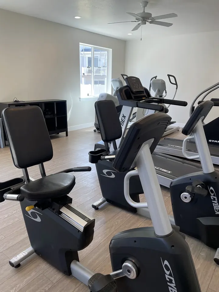 A clean community fitness room with exercise bikes